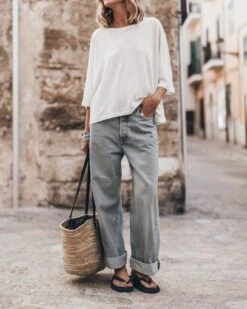 The White Loose Linen T-Shirt -Modern Ladies Wear Store mikuta the white loose linen t shirt the blue baggy jeans the black studded leather sandals the large cesta bag 5017